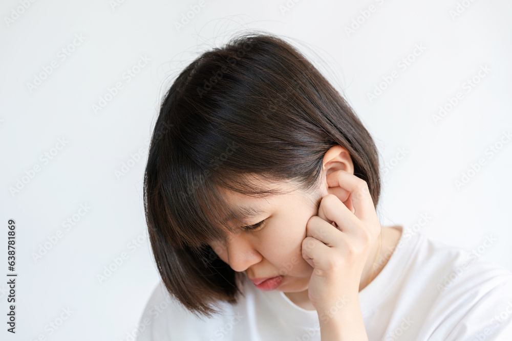 Thai women with short hair touch their ears because itchy or hurt their ears. Thai women with short hair touch their ears because itchy or hurt their ears.