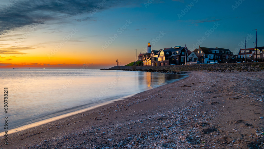 Urk Flevoland Netherlands sunset at the lighthouse and harbor of Urk Holland. Traditional Fishing village Urk. Beautiful sunset during the evening at summer Urk Flevoland Netherlands sunset at the lighthouse and harbor of Urk Holland. Traditional Fishing village Urk. Beautiful sunset during the evening at summer