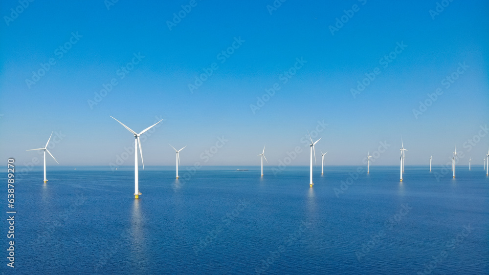 windmill park with clouds and a blue sky, windmill park in the ocean aerial view with wind turbine Flevoland Netherlands Ijsselmeer. Green energy windmill park with clouds and a blue sky, windmill park in the ocean aerial view with wind turbine Flevoland Netherlands Ijsselmeer. Green energy