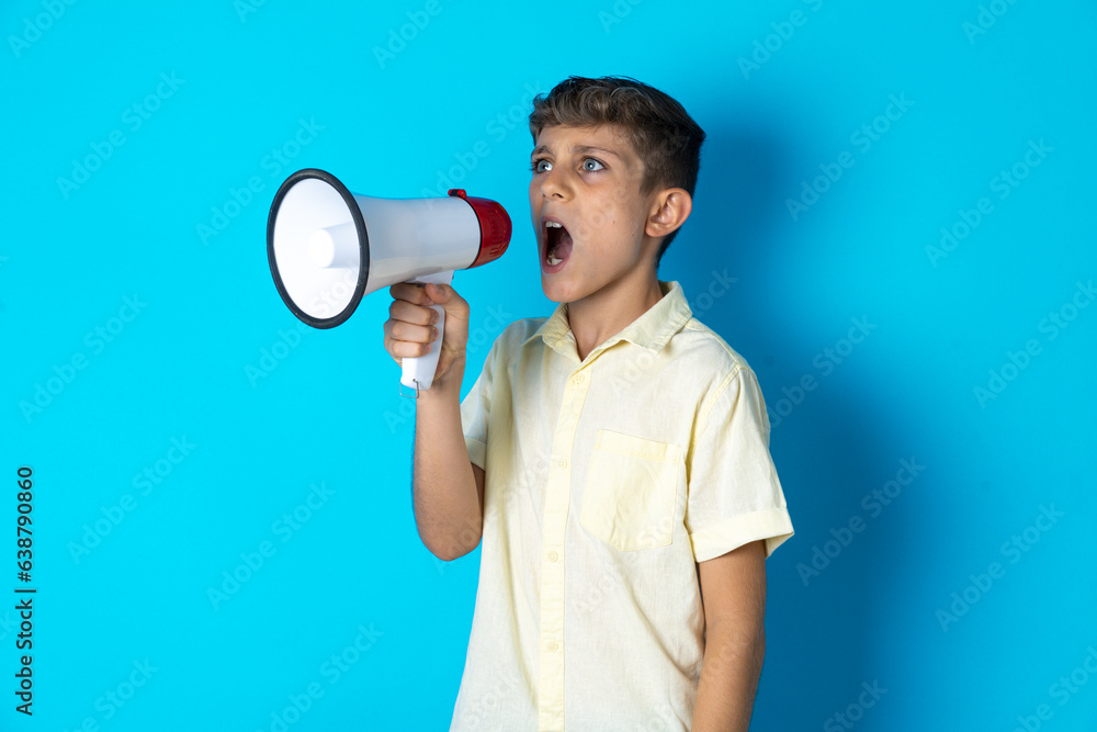 Beautiful kid boy wearing casual shirt Through Megaphone with Available Copy Space Beautiful kid boy wearing casual shirt Through Megaphone with Available Copy Space