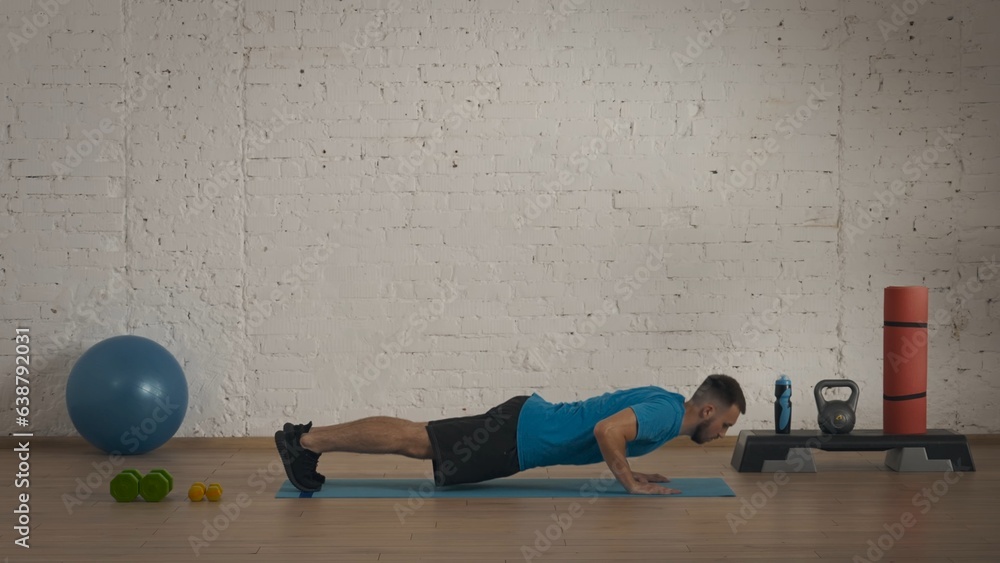 Man fitness coach doing classic push ups exercise for online class. Man fitness coach doing classic push ups exercise for online class.