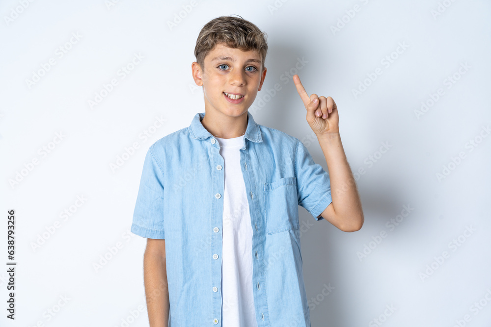 Beautiful kid boy wearing casual clothes showing and pointing up with finger number one while smiling confident and happy. Beautiful kid boy wearing casual clothes showing and pointing up with finger number one while smiling confident and happy.