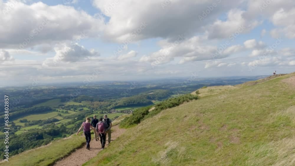 Hikers walking in Malvern Hill and the Great Malvern Town, Area of Outstanding Natural Beauty, UK. Summer Hike Hikers walking in Malvern Hill and the Great Malvern Town, Area of Outstanding Natural Beauty, UK. Summer Hike