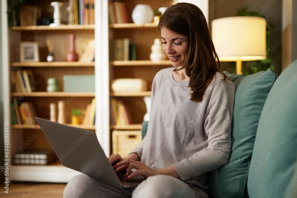 Young smiling woman working remotely from home on laptop Young smiling woman working remotely from home on laptop