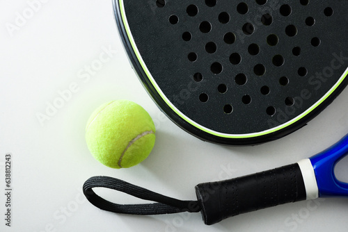 Two blue and black paddle rackets detail on white table