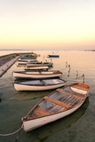 calm idyllic picture about boats next to the pier at sunset in Balatonlelle at Lake Balaton
