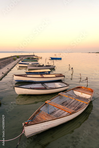 calm idyllic picture about boats next to the pier at sunset in Balatonlelle at Lake Balaton