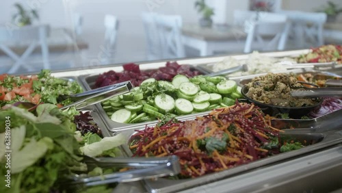 Pan right, display cabinet in a cafe filled with fresh salads. photo