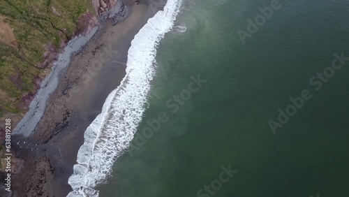 Wallpaper Mural Aerial shot of white waves crashing on the shore at The Copper Coast Waterford Ireland Torontodigital.ca