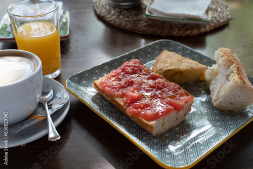Spanish breakfast with orange juice and pan a la catalana fresh tomato puree on toasted slices of bread