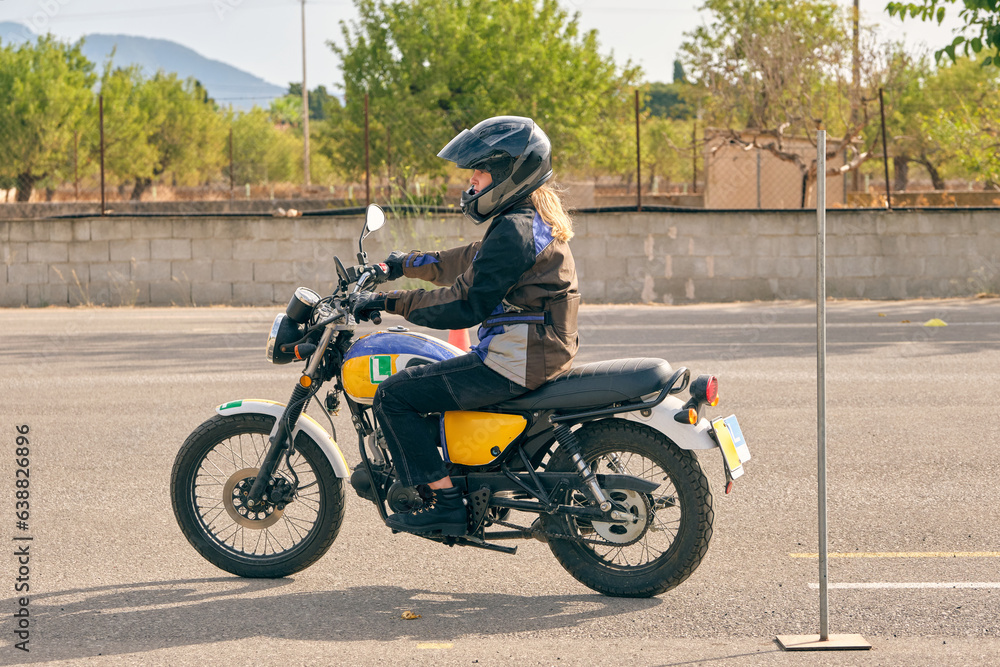 Woman in helmet riding motorcycle on motordrome Woman in helmet riding motorcycle on motordrome