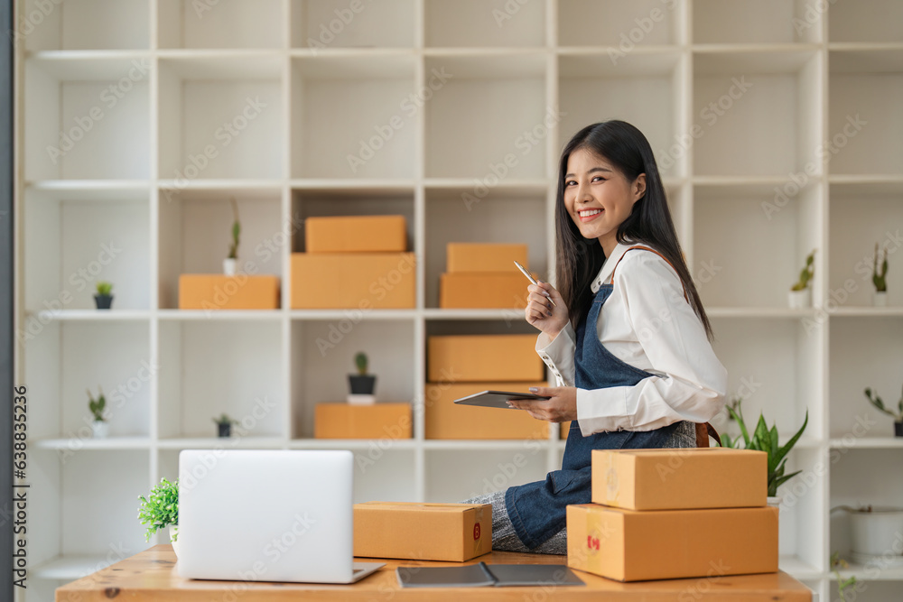Startup SME small business entrepreneur of freelance Asian woman using laptop and box to receive orders online to prepare to pack sell to customers, online sme business ideas Startup SME small business entrepreneur of freelance Asian woman using laptop and box to receive orders online to prepare to pack sell to customers, online sme business ideas