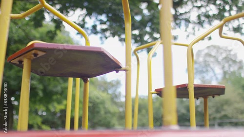 Abstract angle of empty children's roundabout in a playground spinning, in slow motion