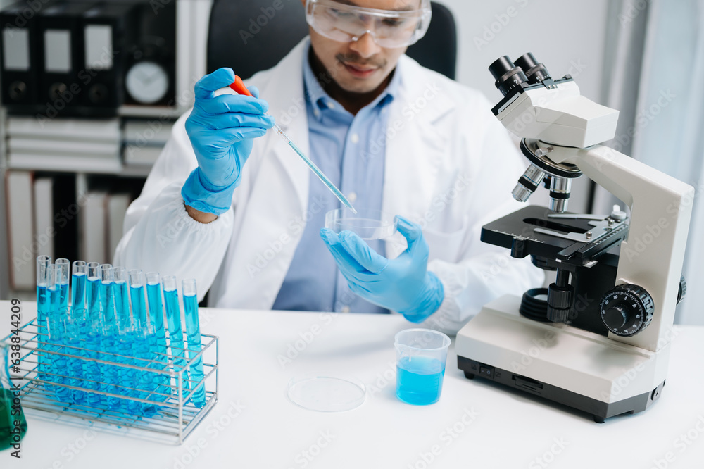Scientist mixing chemical liquids in the chemistry lab. Researcher working in chemical laboratory. Scientist mixing chemical liquids in the chemistry lab. Researcher working in chemical laboratory.
