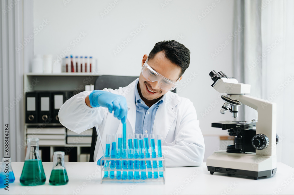 Modern medical research laboratory. male scientist working with micro pipettes analyzing biochemical samples, advanced science chemical laboratory medicine. Modern medical research laboratory. male scientist working with micro pipettes analyzing biochemical samples, advanced science chemical laboratory medicine.