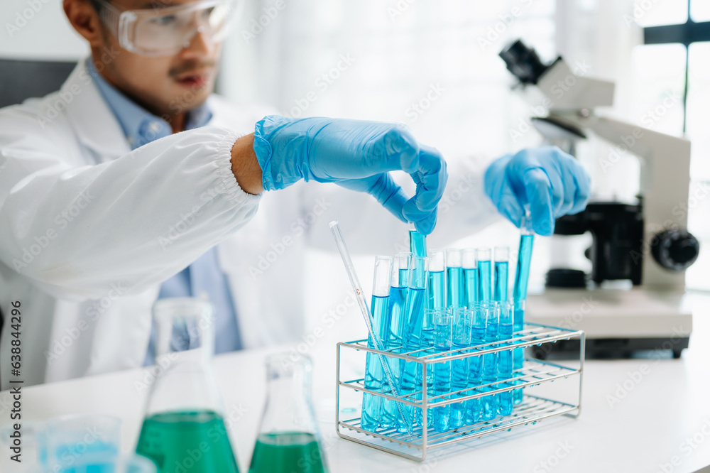 Mmale biotechnologist testing new chemical substances in a laboratory... Mmale biotechnologist testing new chemical substances in a laboratory...