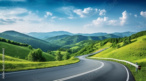 Fotografia, Obraz A winding road stretching ahead, flanked by verdant trees and hills, under the clear blue sky