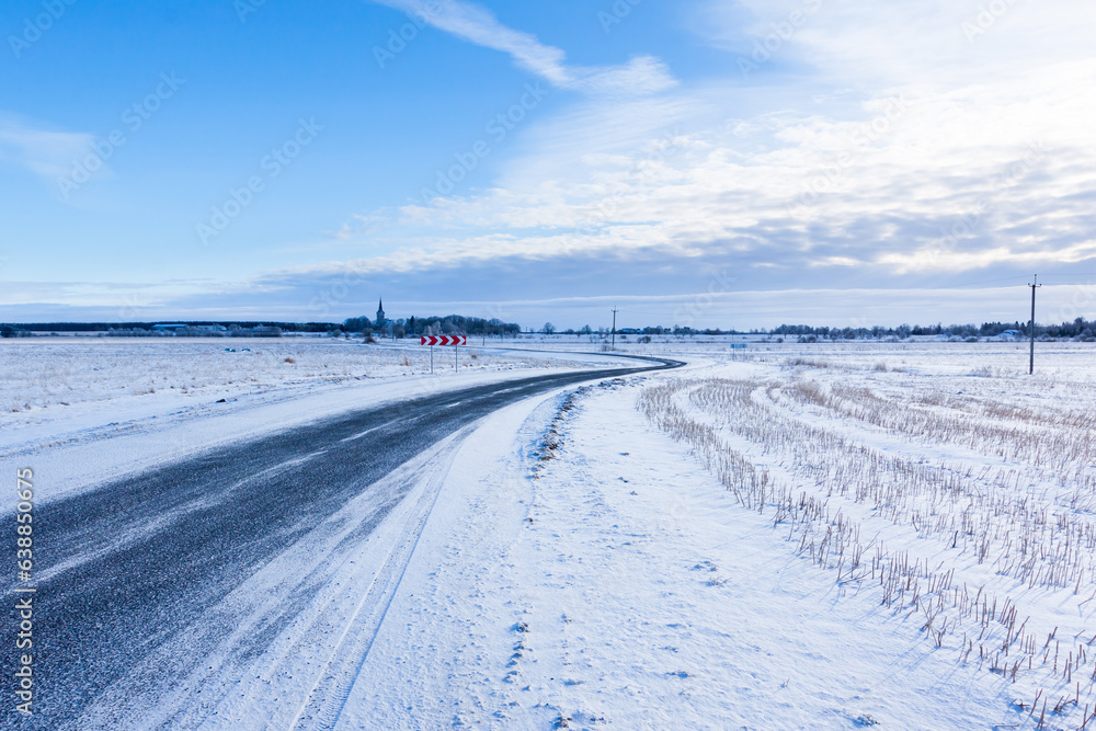 Countryside road through winter field