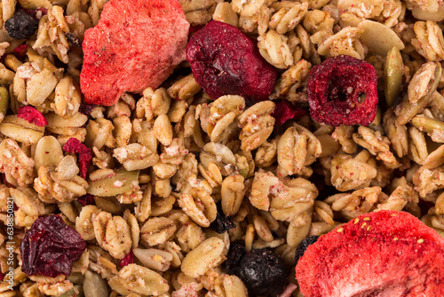 Muesli oat cereals close up background with dry fruits