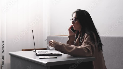 Desperate frustrated bank customer emotionally talking on the phone. Facing fraud, cost overruns, online payment problems, credit card blocking, bankruptcy. photo