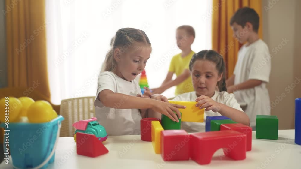 small children play lifestyle with toys at home. happy family childhood dream concept. a group of little kids develops playing with colorful cubes and pyramids. educational games with colored toys small children play lifestyle with toys at home. happy family childhood dream concept. a group of little kids develops playing with colorful cubes and pyramids. educational games with colored toys
