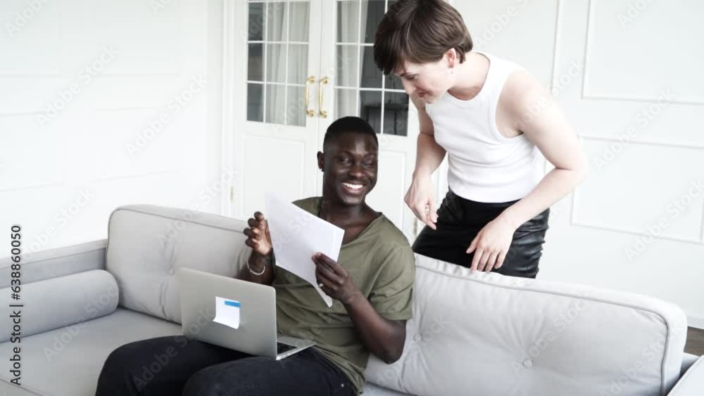 Young couple watching laptop together, receiving good news Young couple watching laptop together, receiving good news