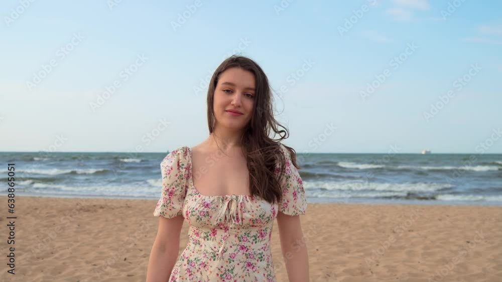 Carefree woman walking at sea beach. Happy sexy female at sand coastline in light dress. Tourist at ocean resort during summer vacation. Relax leisure activity, active lifestyle, cheerful confident Carefree woman walking at sea beach. Happy sexy female at sand coastline in light dress. Tourist at ocean resort during summer vacation. Relax leisure activity, active lifestyle, cheerful confident