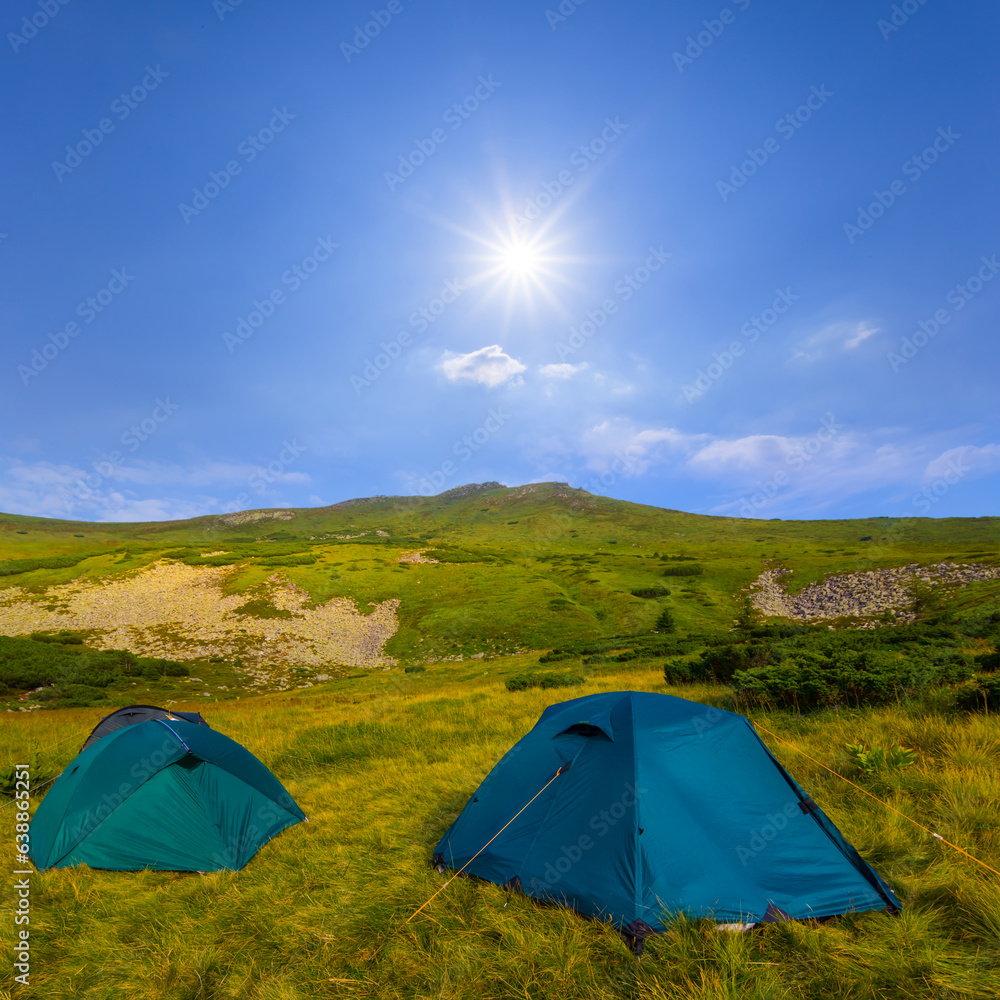 touristic camp on green mountain valley at the sunny day, mountain travel scene