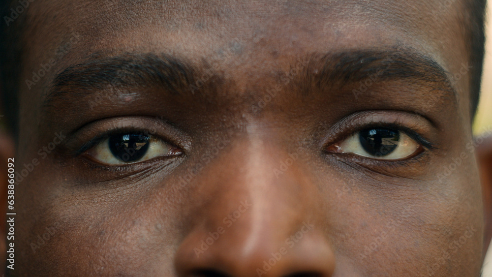 Close up cropped view detail ad male African American ethnic dark eyes close open blink ophthalmology eyesight see look vision sight eye problem strain ill sick facial expression looking laser surgery