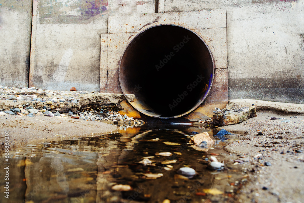 © Dmitry - Large sewage pipe in a concrete wall. Pollution of the environment by waste from industrial enterprises. Close-up