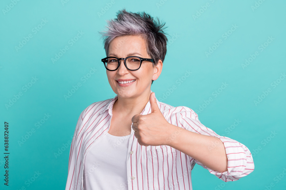 Portrait of attractive middle age white hair woman raise thumb finger up social network like blog isolated teal color background Portrait of attractive middle age white hair woman raise thumb finger up social network like blog isolated teal color background