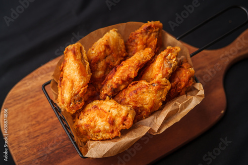 Crispy fried chicken wings on a chopping board