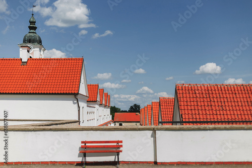 white walls and red tile roofs of camaldolese monk's houses in Wigry village, Poland