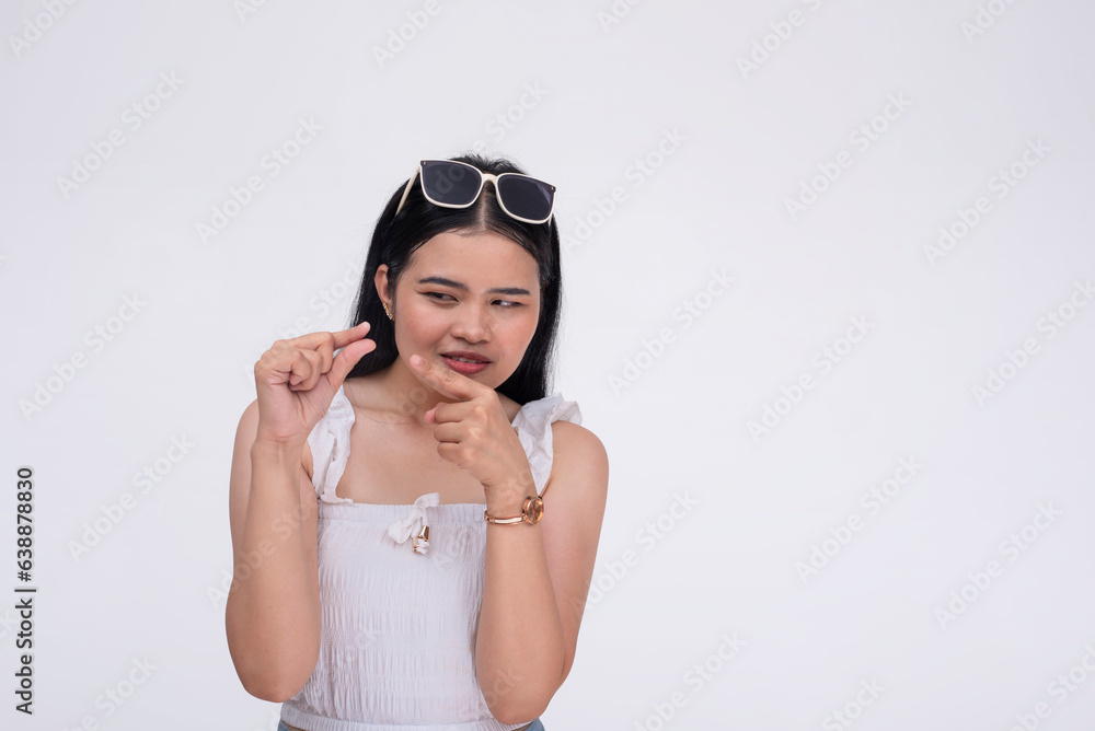 A mean young asian woman belittling the size of your package. Mocking gesture with fingers. Isolated on a white background. A mean young asian woman belittling the size of your package. Mocking gesture with fingers. Isolated on a white background.