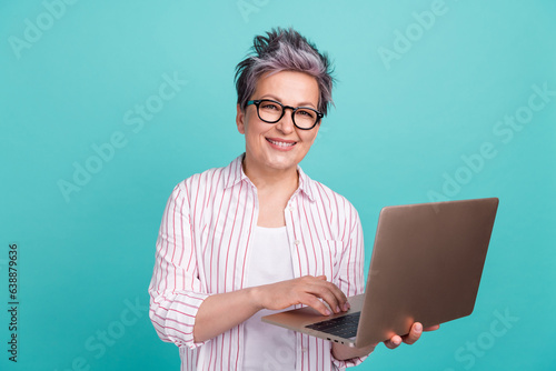 Portrait photo of young model hr department employee woman using laptop find new applicants for job isolated on aquamarine color background photo