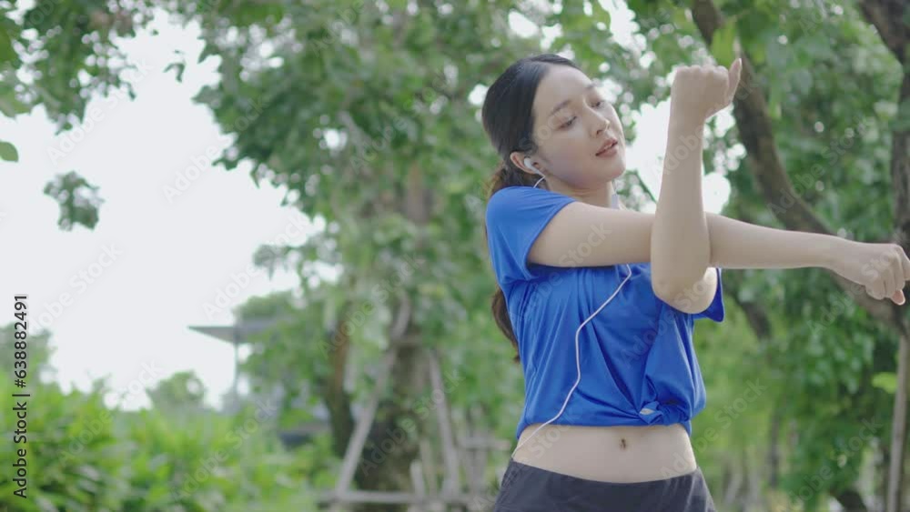 Strong athletic asian woman stretching warming up before running. Fit sport girl stretching her body warm up before workout outdoor. The girl in sportswear exercises outside for health and wellbeing Strong athletic asian woman stretching warming up before running. Fit sport girl stretching her body warm up before workout outdoor. The girl in sportswear exercises outside for health and wellbeing