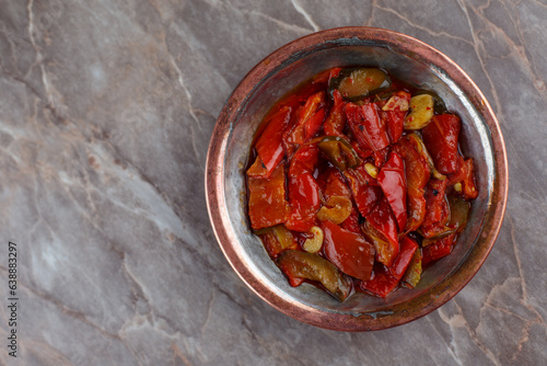 Red pepper with olive oil appetizer in a bronze bowl 