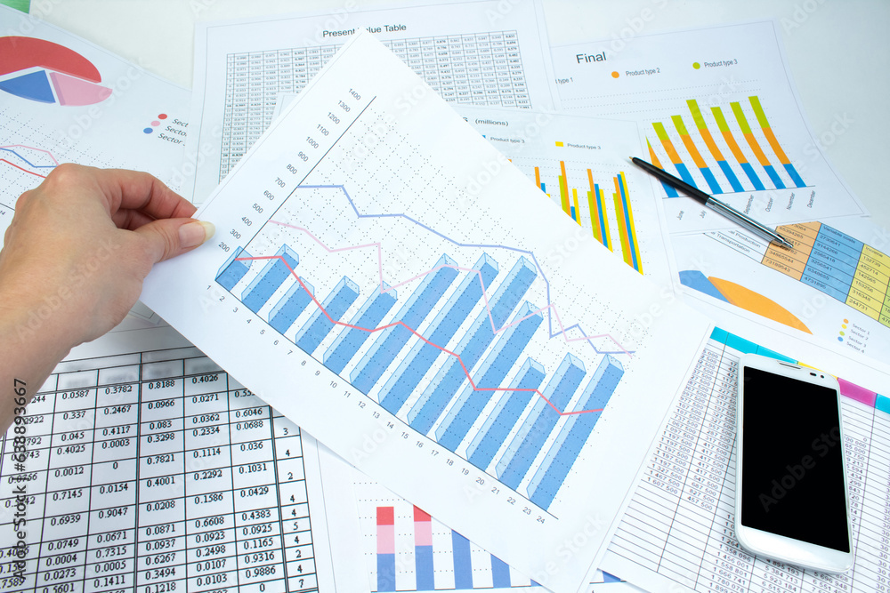 Financial printed paper charts, graphs and diagrams on the table. Top view Financial printed paper charts, graphs and diagrams on the table. Top view