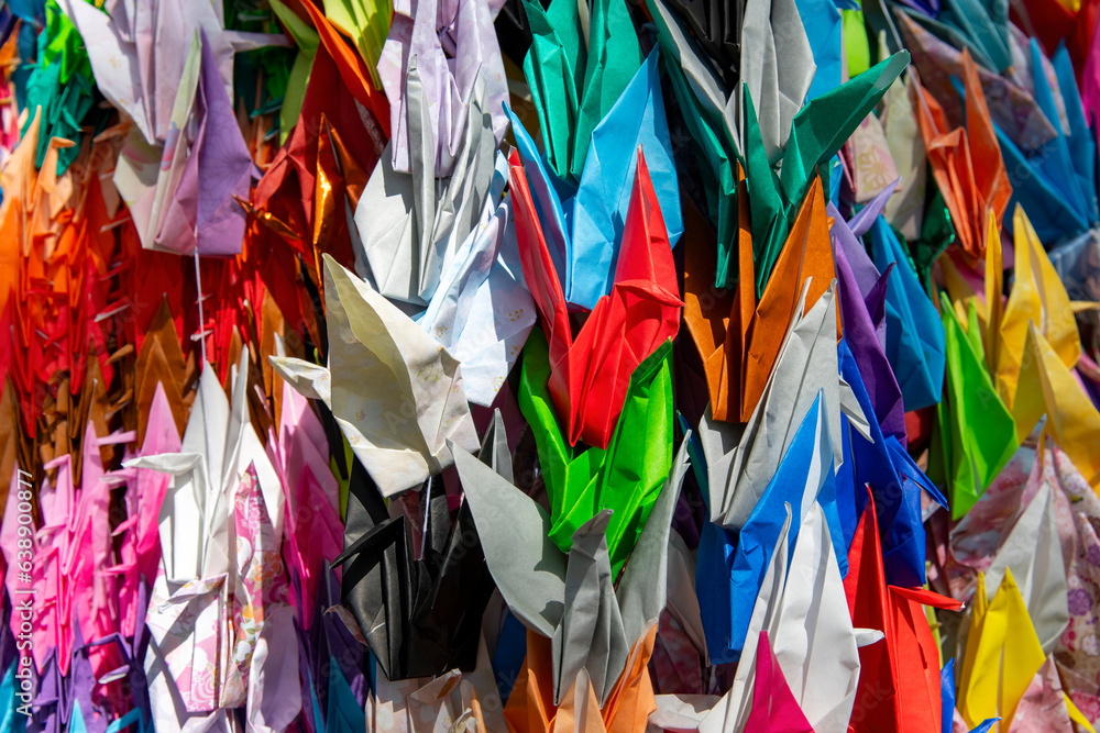 Image filling close up view of colorful Origami paper crane birds, a traditional Japanese game of folding elaborately designed paper into many shapes