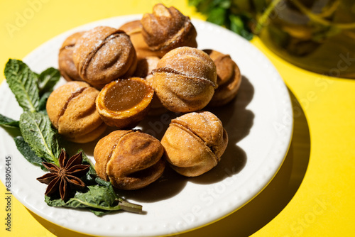 Homemade nut cookies with condensed milk on a yellow background.