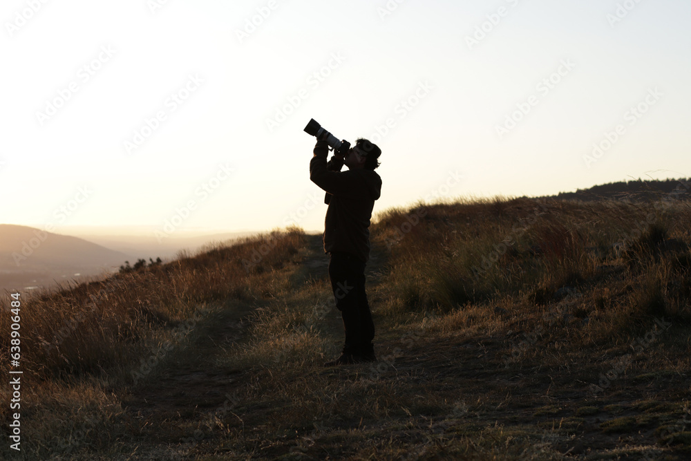 Photograph silhouette of photographer in a sunset in the mountains of Peru. Concept of lifestyles, professions and nature. Photograph silhouette of photographer in a sunset in the mountains of Peru. Concept of lifestyles, professions and nature.