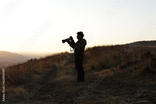 Photograph silhouette of photographer in a sunset in the mountains of Peru. Concept of lifestyles, professions and nature. © artrolopzimages