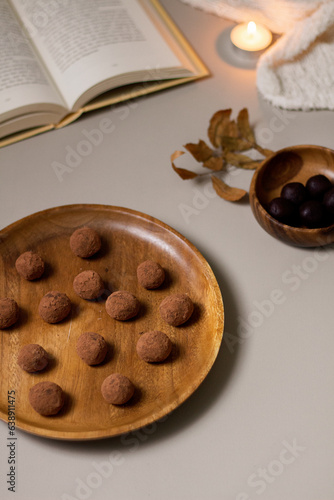 Chocolate truffles covered with cocoa powder. Gray background. Delicious dessert concept.