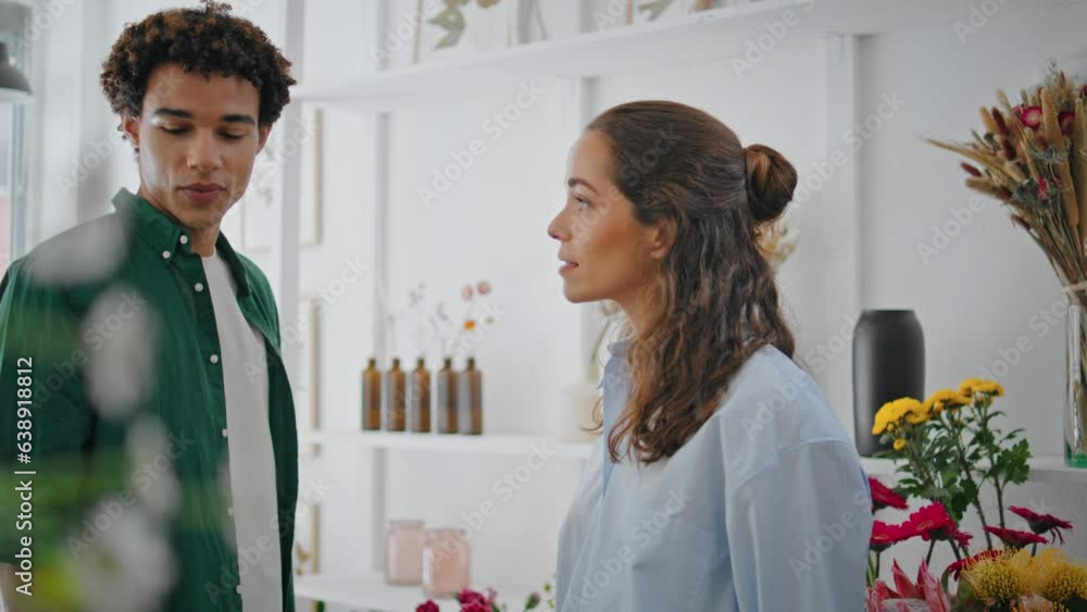Calm bouquet seller talk client in shop. Dreamy man buy flowers composition gift Calm bouquet seller talk client in shop. Dreamy man buy flowers composition gift
