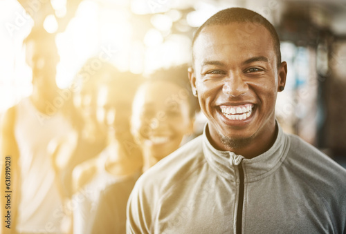 Fitness, black man and portrait with team, workout class and training in a health and wellness club. Lens flare, happy and smile with diversity and personal trainer with exercise, sports and group