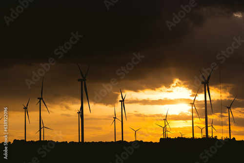 sunset at wind turbine mountain hill landscape of eco power generator and future energy saving environment