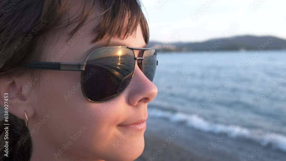 Girl against picturesque shore. A view of nice picturesque sea with a happy child on the sandy beach in the day light. Girl against picturesque shore. A view of nice picturesque sea with a happy child on the sandy beach in the day light.