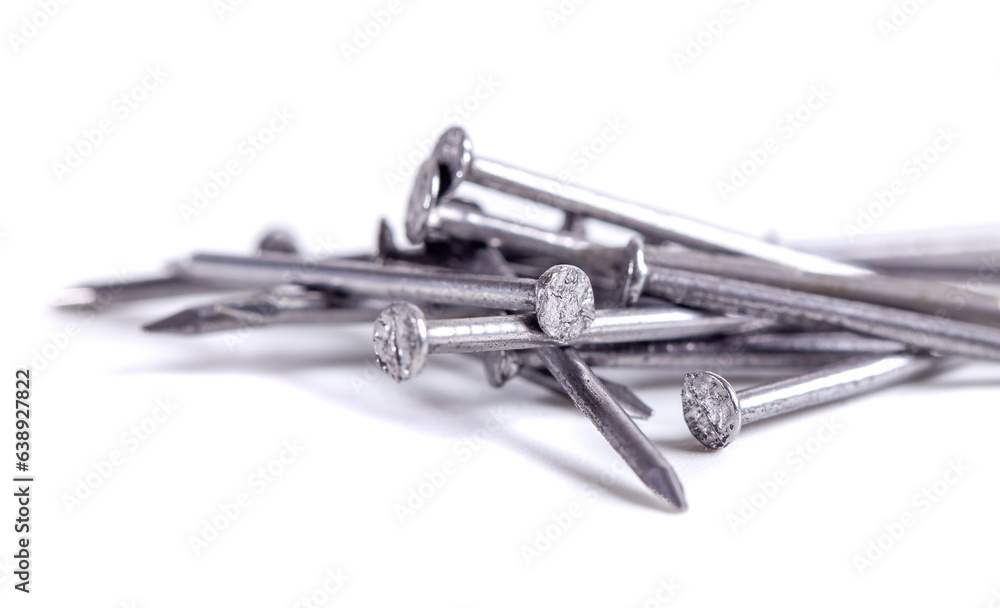 Pile of small grey metal nails isolated on white background. Close-up