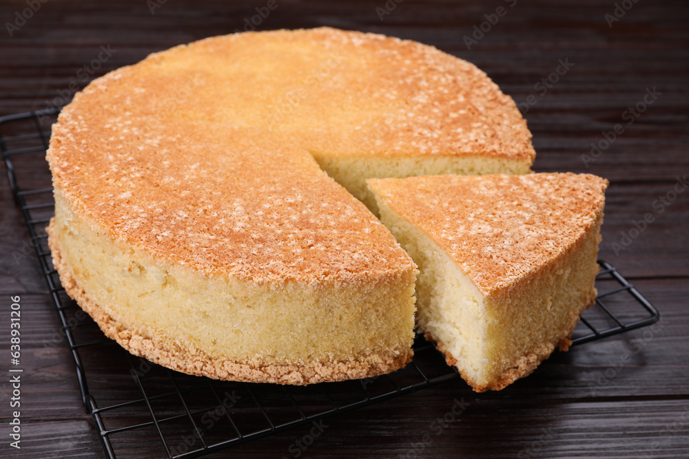 Tasty sponge cake on wooden table, closeup Tasty sponge cake on wooden table, closeup