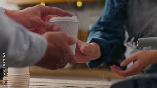 The client, the master barista, dispenses coffee in a modern coffee shop. Slow motion barista is in the workplace new ways of preparing drinks, waitress. Getting a takeaway drink in a paper cup